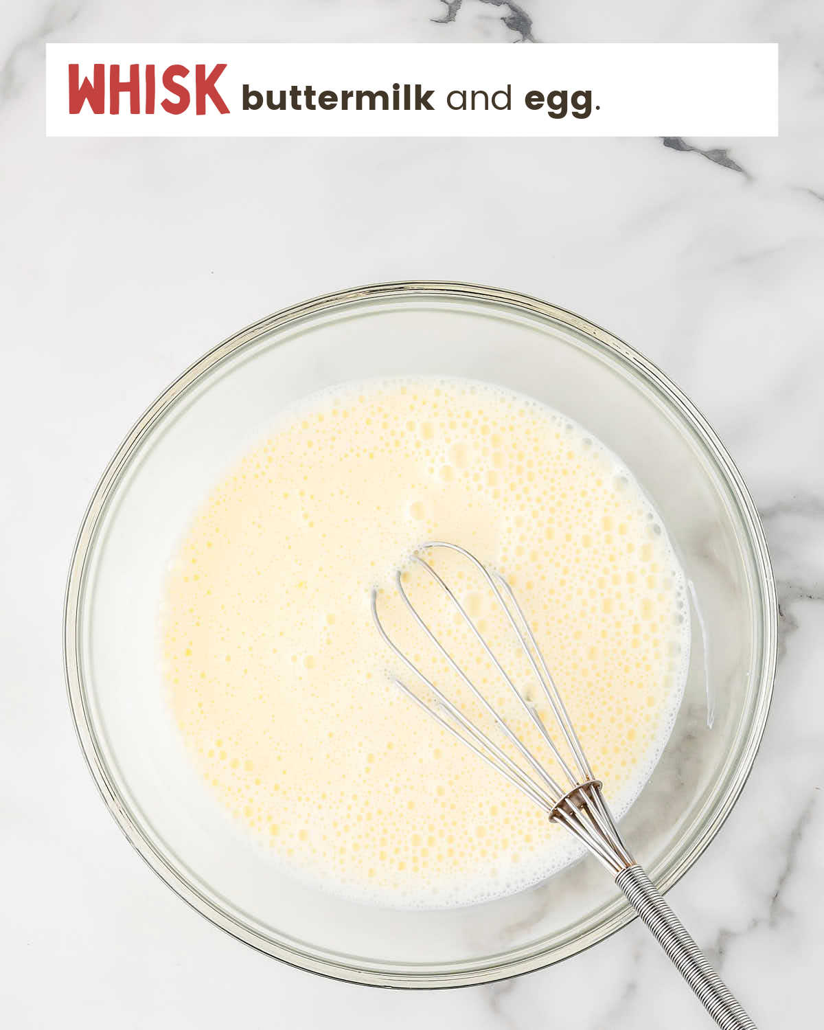 Whisked buttermilk and egg in a bowl.