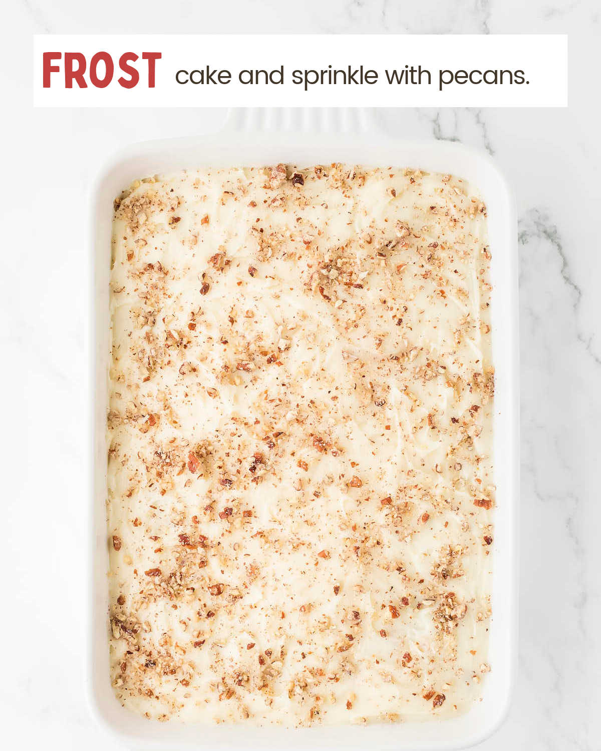 Frosted carrot cake with topped pecans.