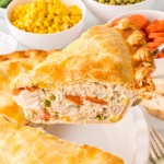 A slice of Chicken Pot Pie being lifted out of the pan.
