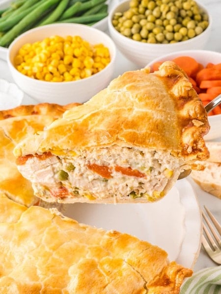 A slice of Chicken Pot Pie being lifted out of the pan.