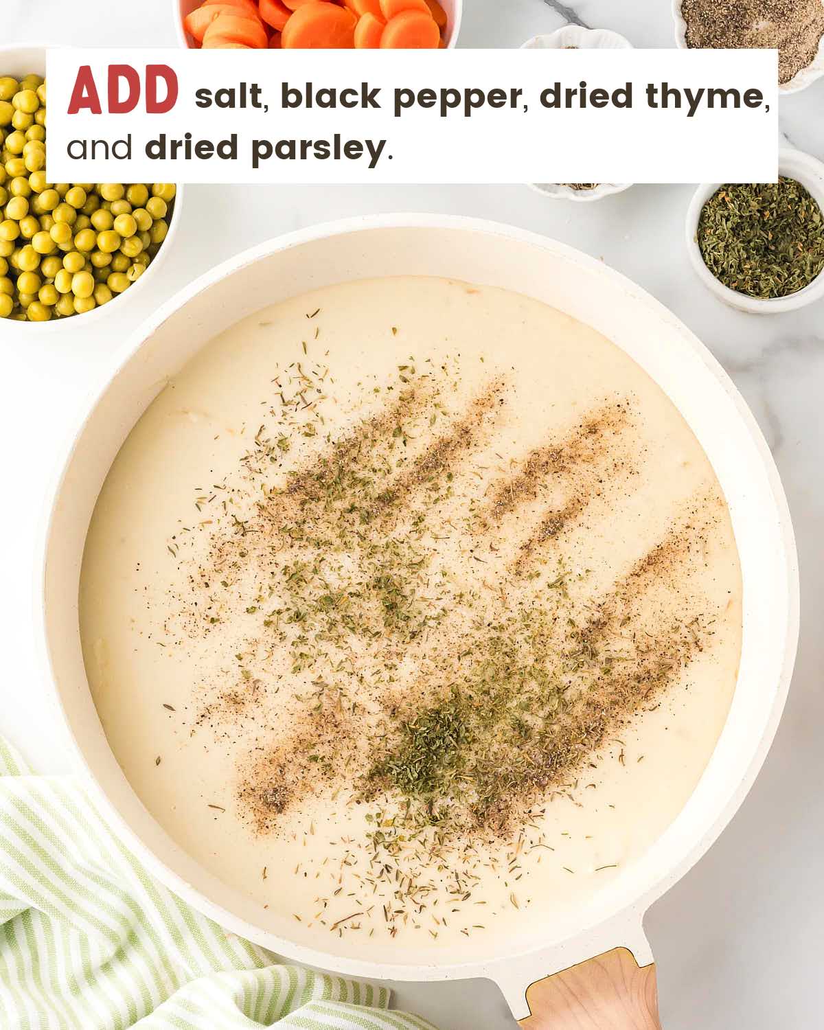Spices on top of a chicken pot pie filling heavy cream mixture.