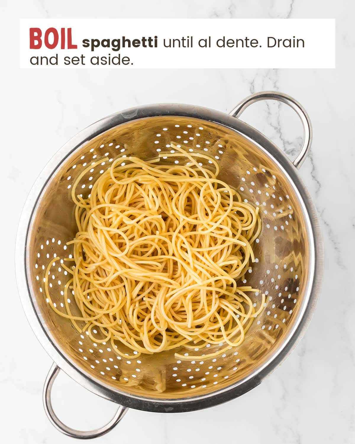 Cooked spaghetti in a strainer. 