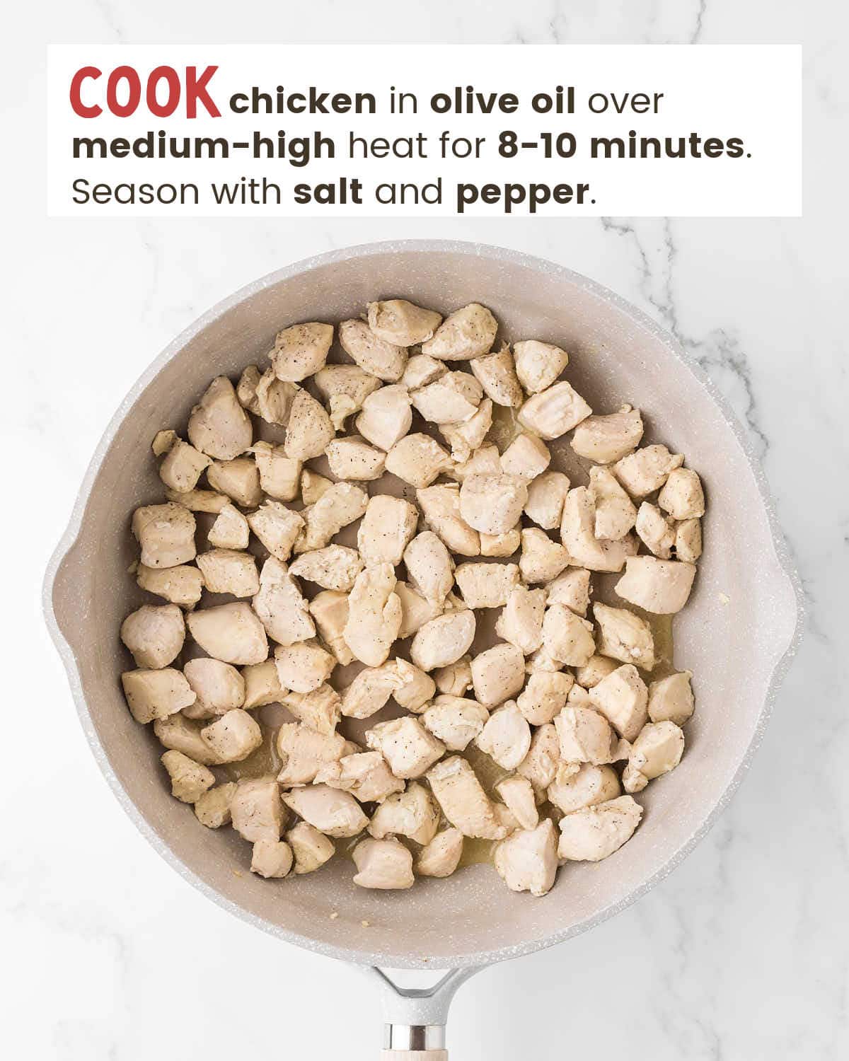 Diced cooked chicken cubes in a skillet.