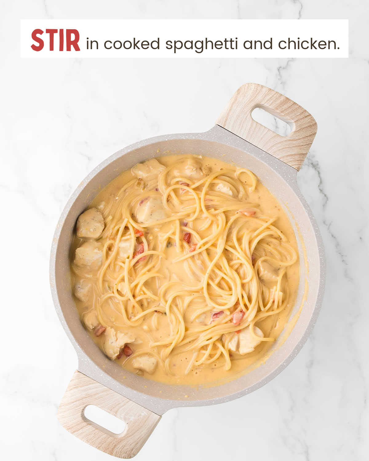 Spaghetti and chicken in a cheesy Rotel sauce in a pot.