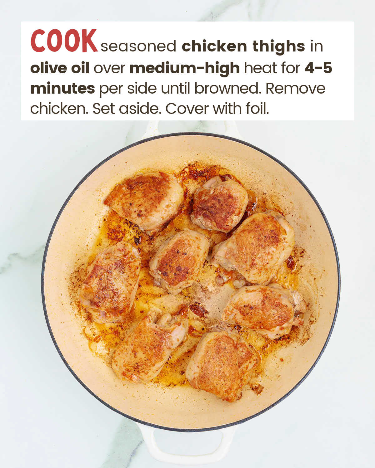 Browned chicken thighs in a skillet.