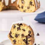 A slice of frosted Chocolate Chip Bundt Cake.