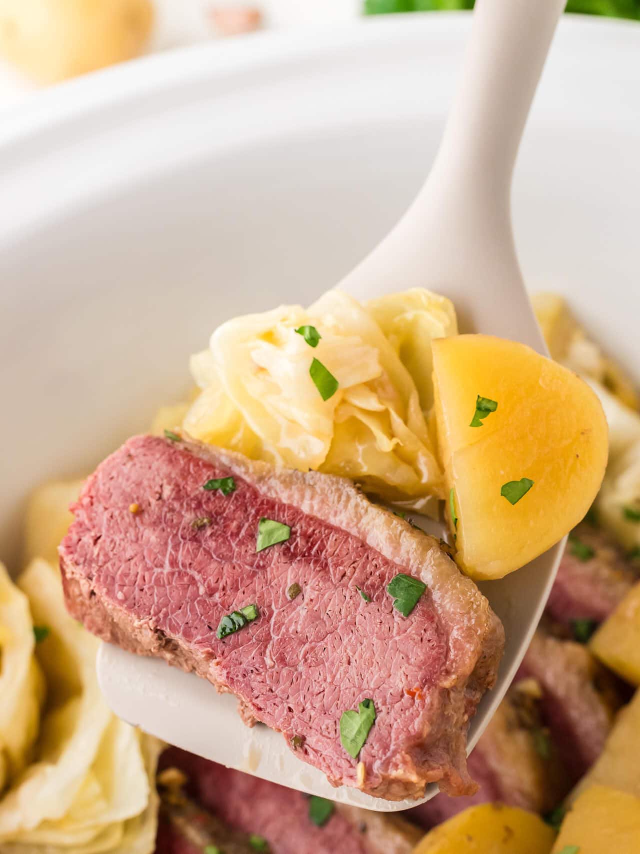 A spatula filled with corned beef, cabbage, and potatoes.