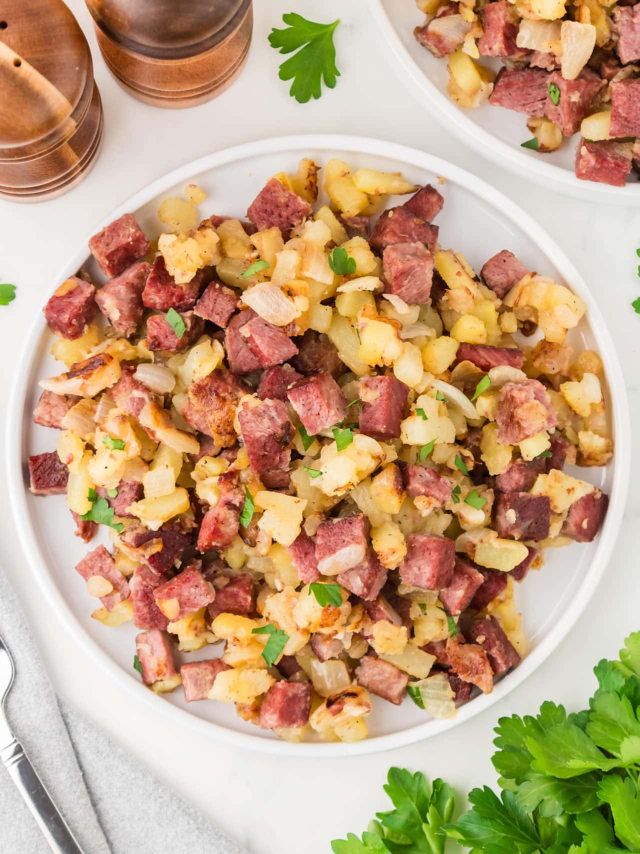 Top down view of Corned Beef Hash on a white plate.