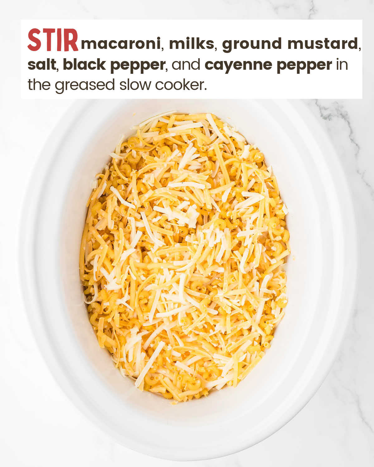 Cheeses cover macaroni in a crockpot. 