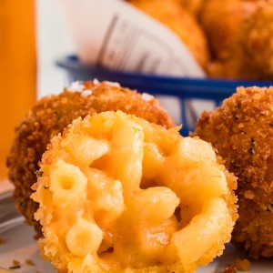 Several Mac and Cheese Bites on a white plates.