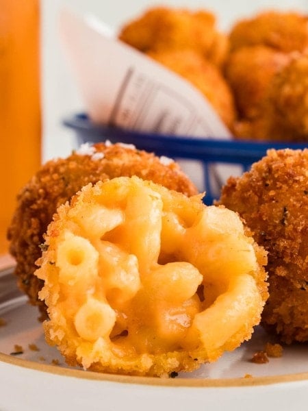 Several Mac and Cheese Bites on a white plates.