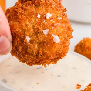 Dipping a Mac and Cheese Bite into dipping sauce.