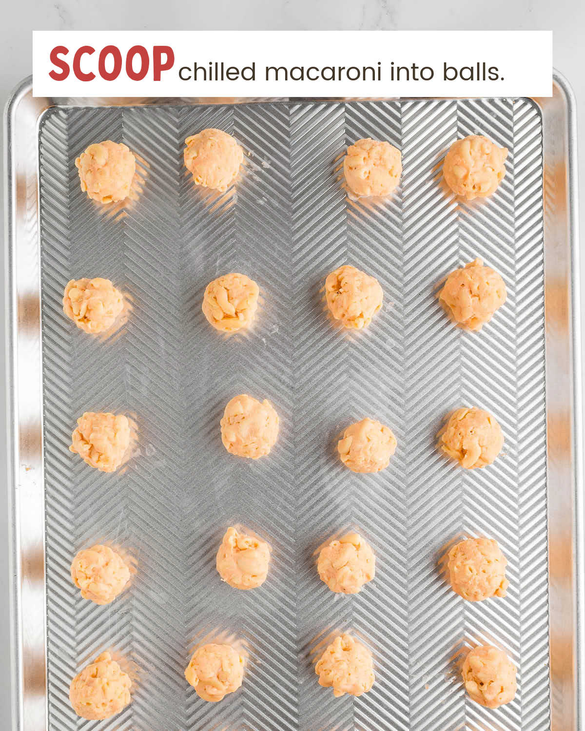 Mac and cheese balls on a baking tray.