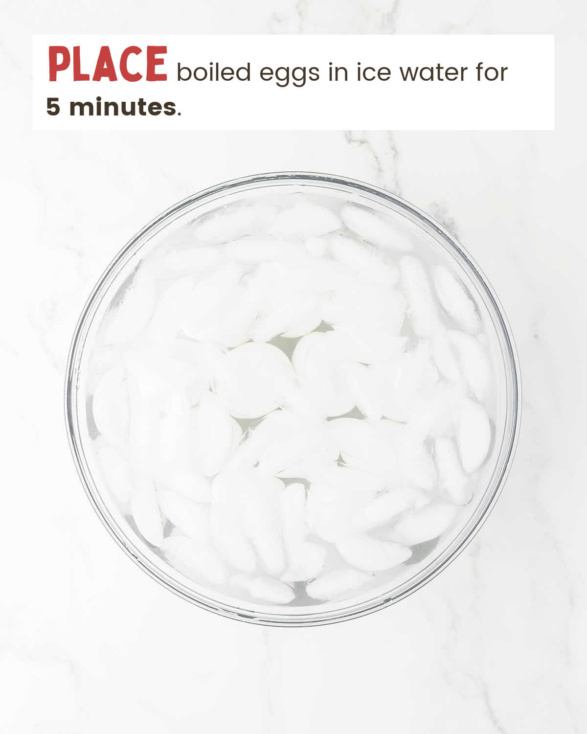 A bowl with water and ice cubes.