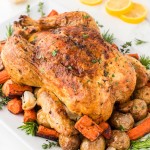 Roasted Chicken served over roast potatoes and carrots.