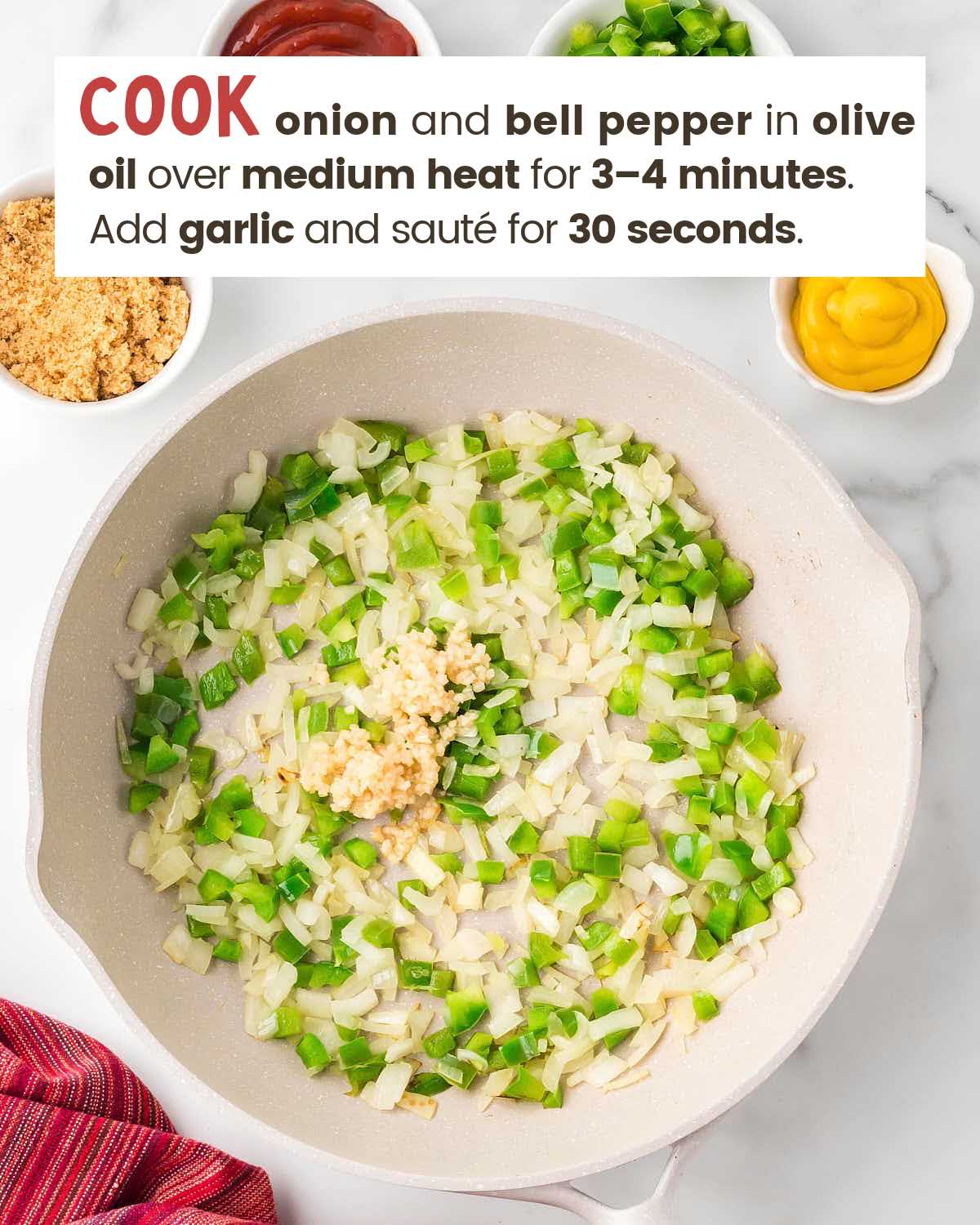 Chopped green bell peppers and onions and minced garlic in a skillet.