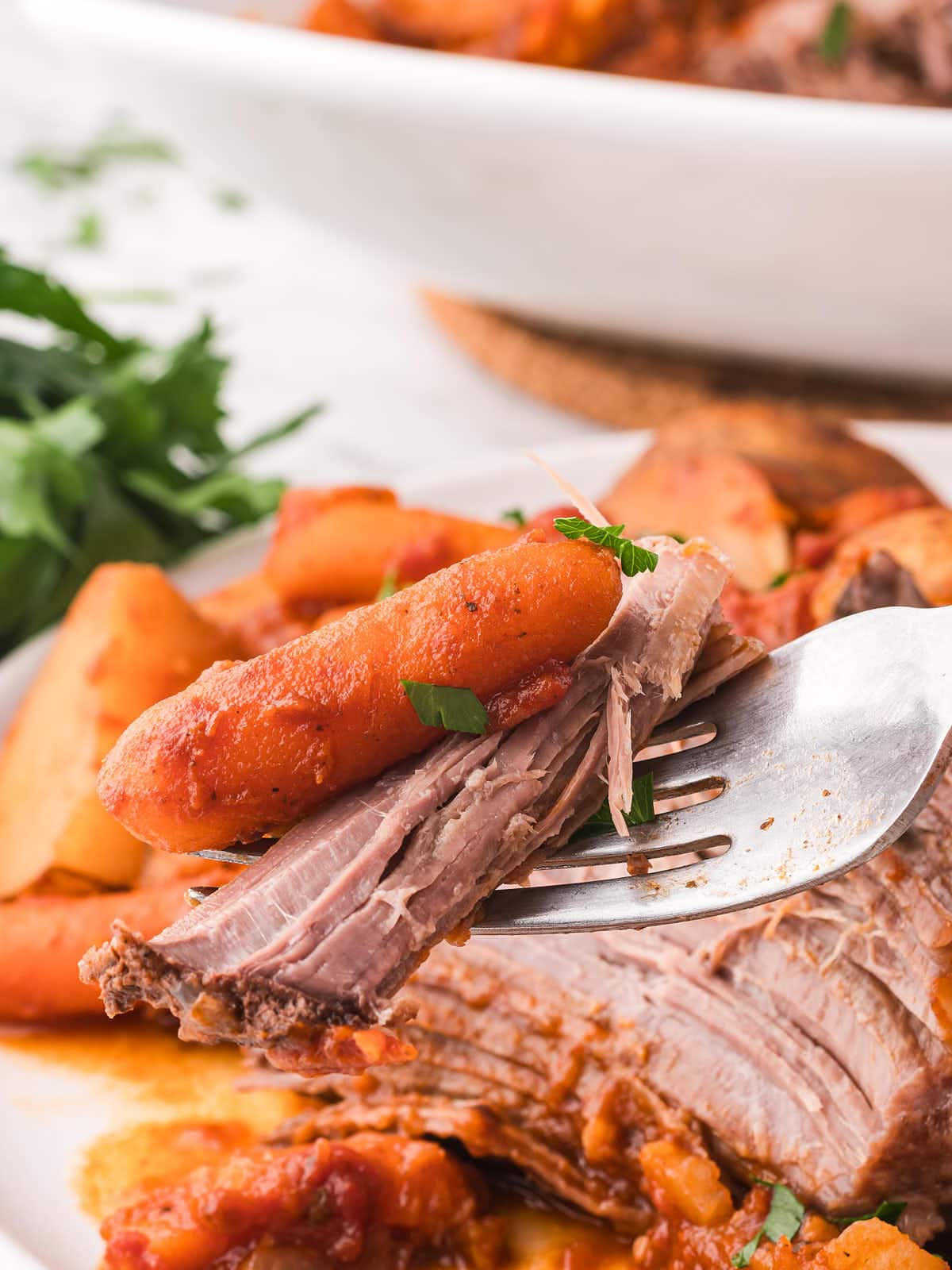 I notice the user prompt provided is empty. Without content to analyze, I cannot determine the primary language or create a meaningful summary of thinking requirementsA fork holding a tender piece of slow cooker pot roast with a baby carrot.