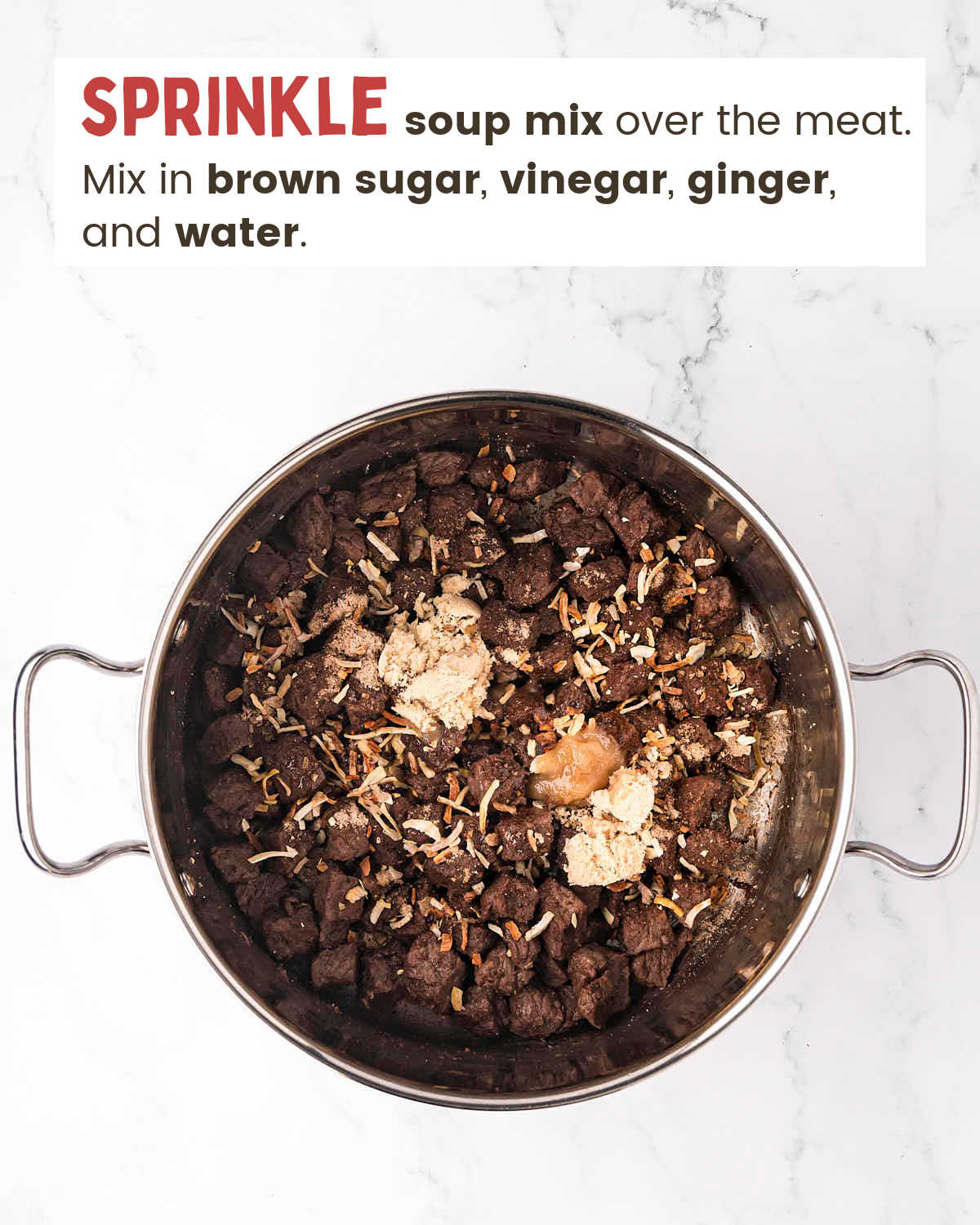 Browned steak pieces sprinkled with seasonings in a pot.