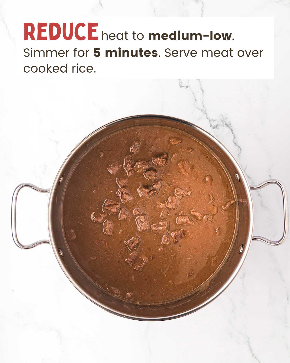 Browned steak pieces covered with broth in a pot.
