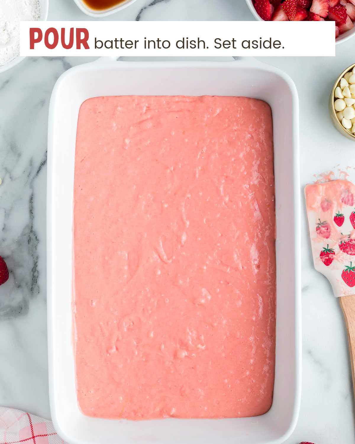 Strawberry cake batter in a baking dish.