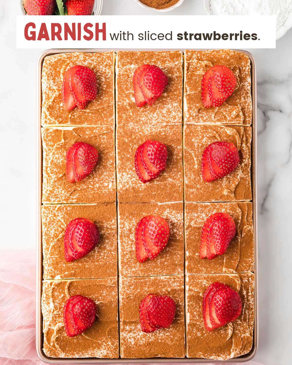 Tres Leches Cake topped with sliced strawberries.