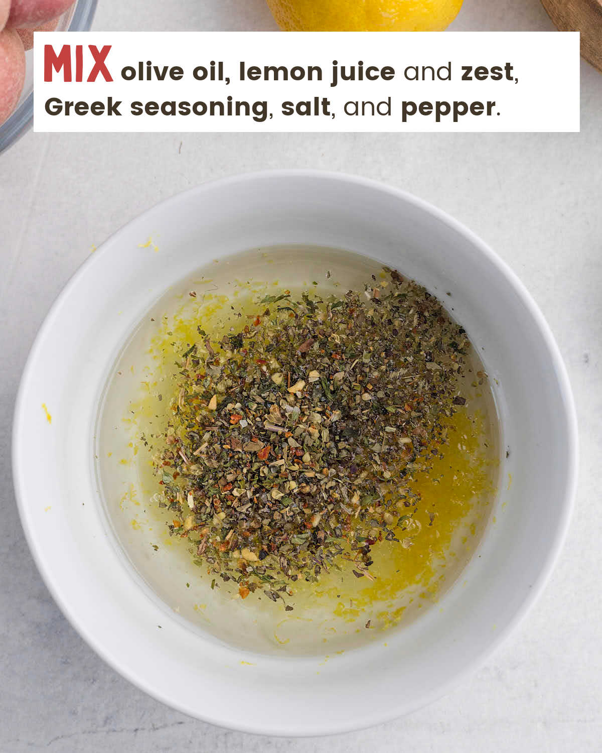 Olive oil, lemon juice, lemon zest and Greek seasonings in a bowl. 