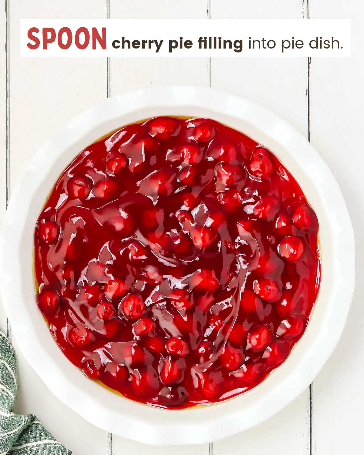 Cherry pie filling in a white pie plate. 