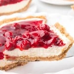 A slice of Cherry Cream Cheese Pie on a cake lifter.