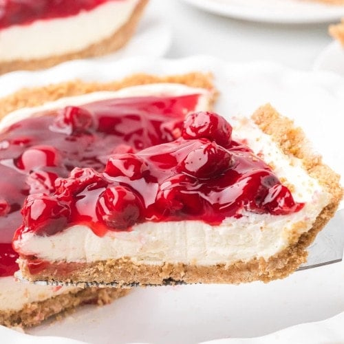 A slice of Cherry Cream Cheese Pie on a cake lifter.