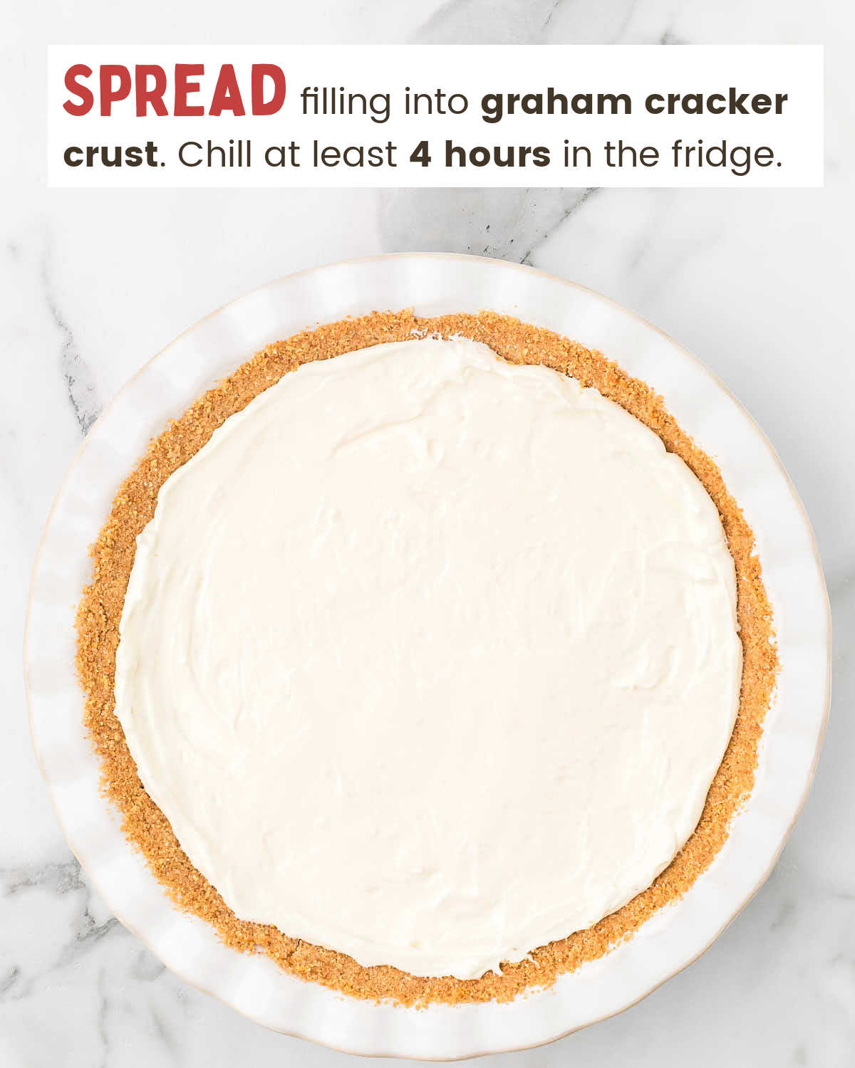 Cream cheese mixture on top of a graham cracker crust in a white pie plate.