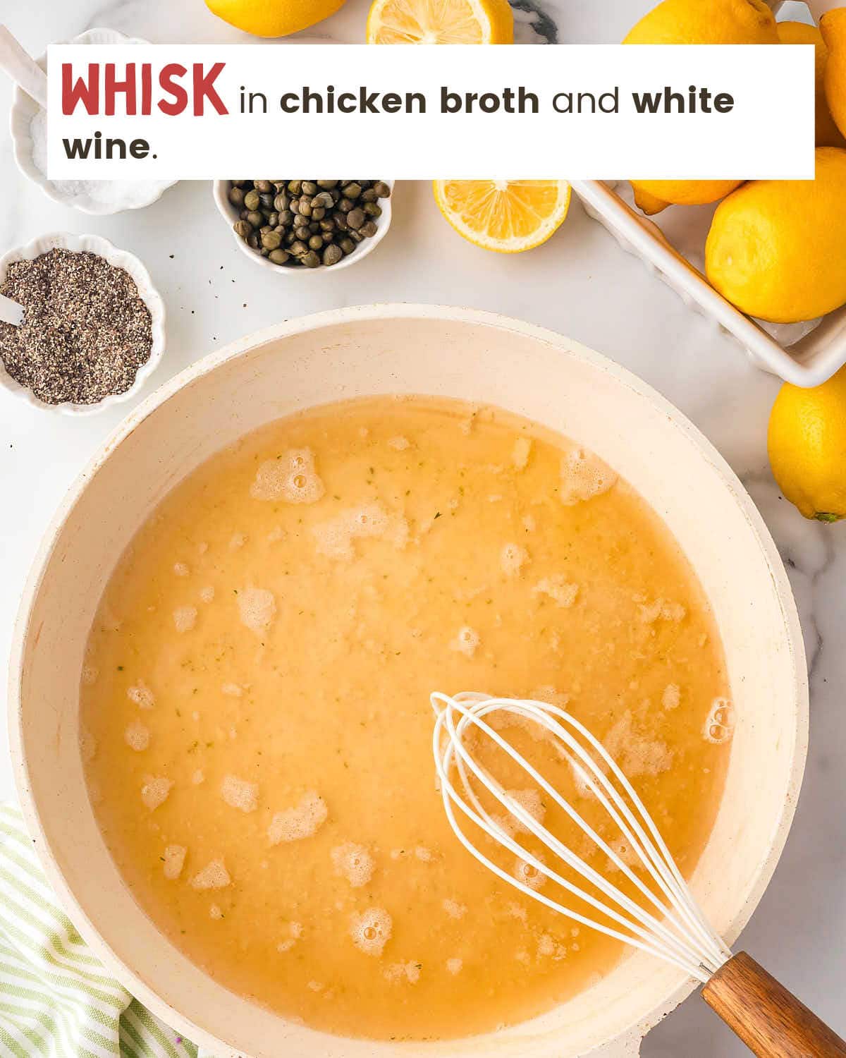 A whisk in a skillet with chicken broth.