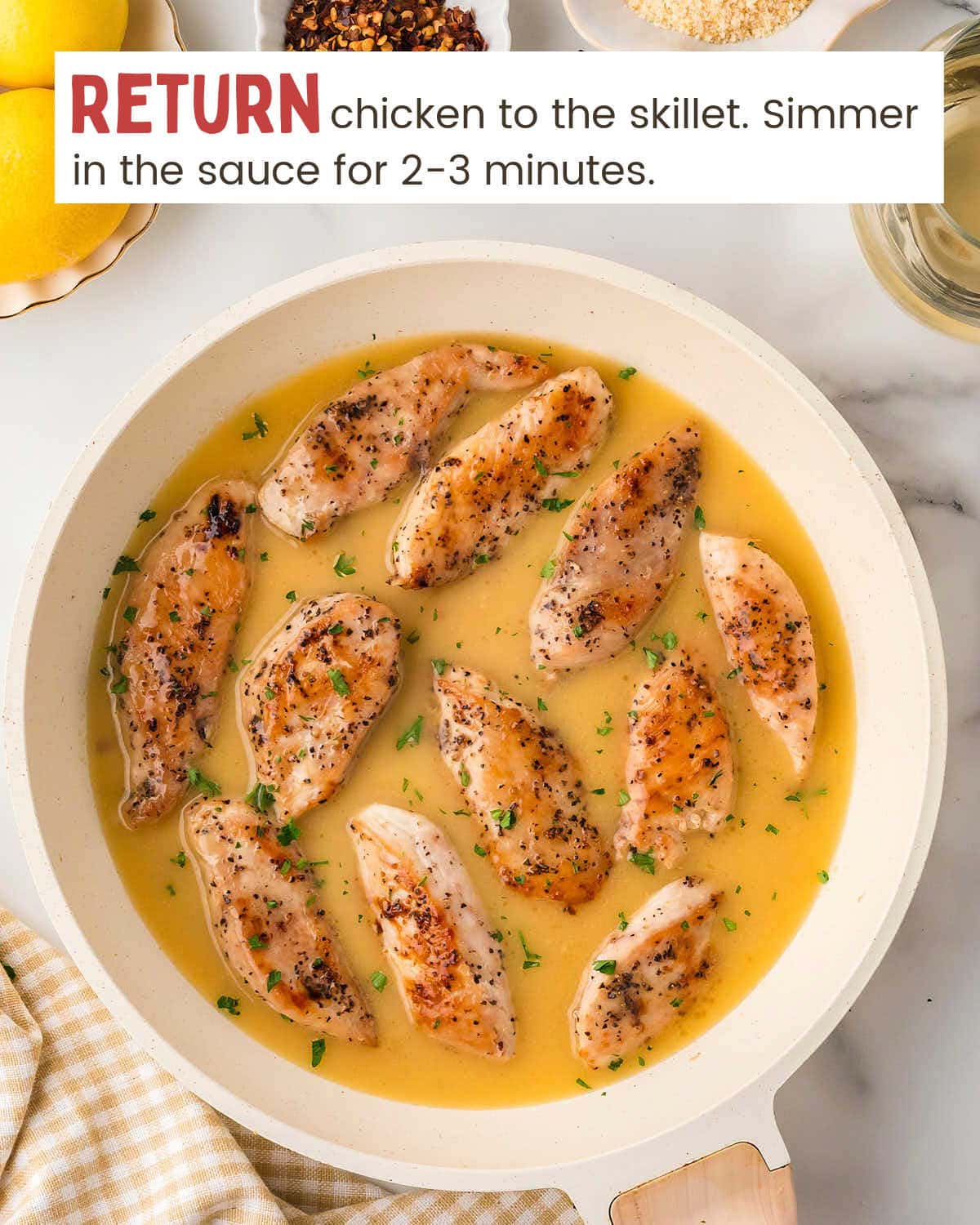 Chicken tenderloins in a scampi sauce in a skillet.