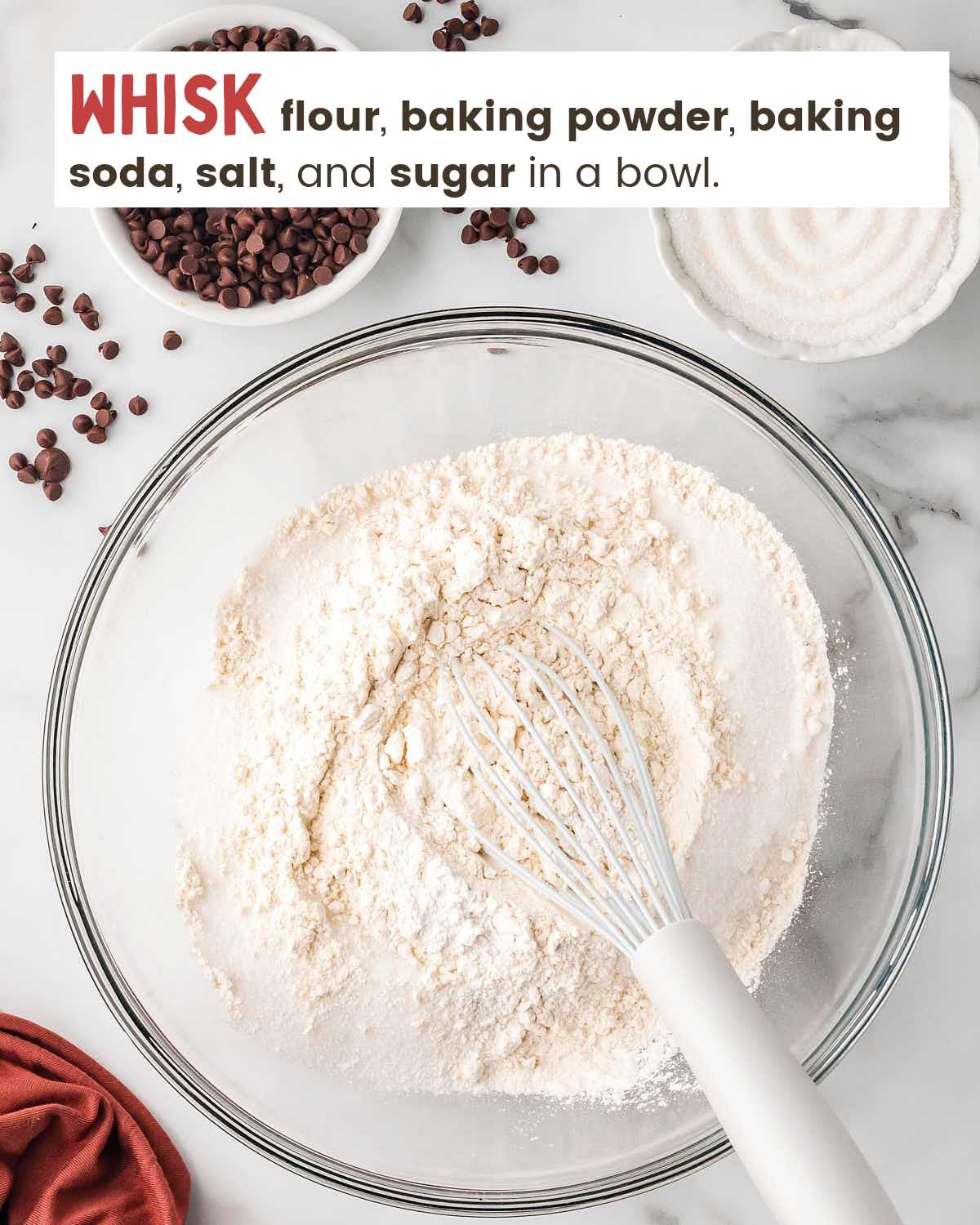 Dry ingredients for muffins in a mixing bowl with a whisk. 