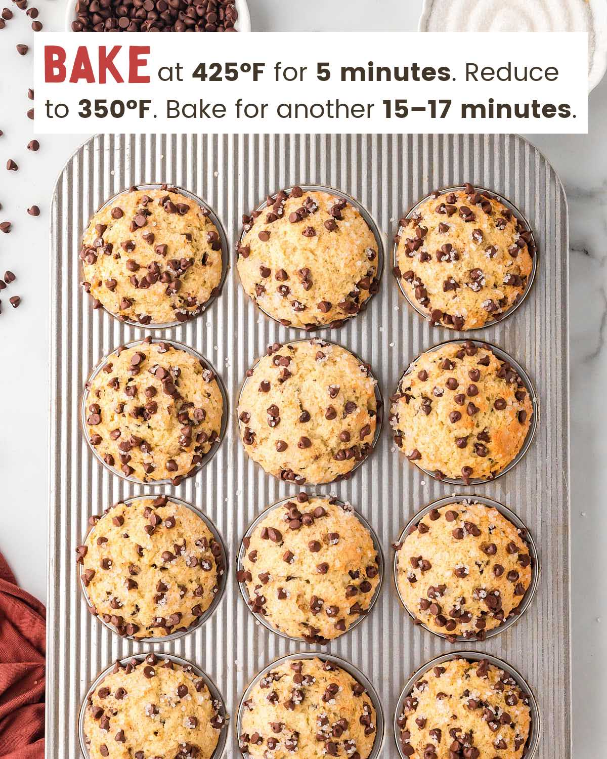 Baked chocolate chip muffins in a muffin tin.