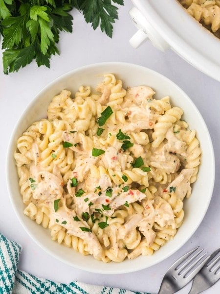 Top-down view of a bowl of Garlic Parmesan Chicken Pasta made in a Crock Pot.