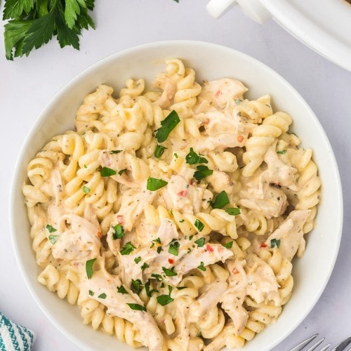 Top-down view of a bowl of Garlic Parmesan Chicken Pasta made in a Crock Pot.