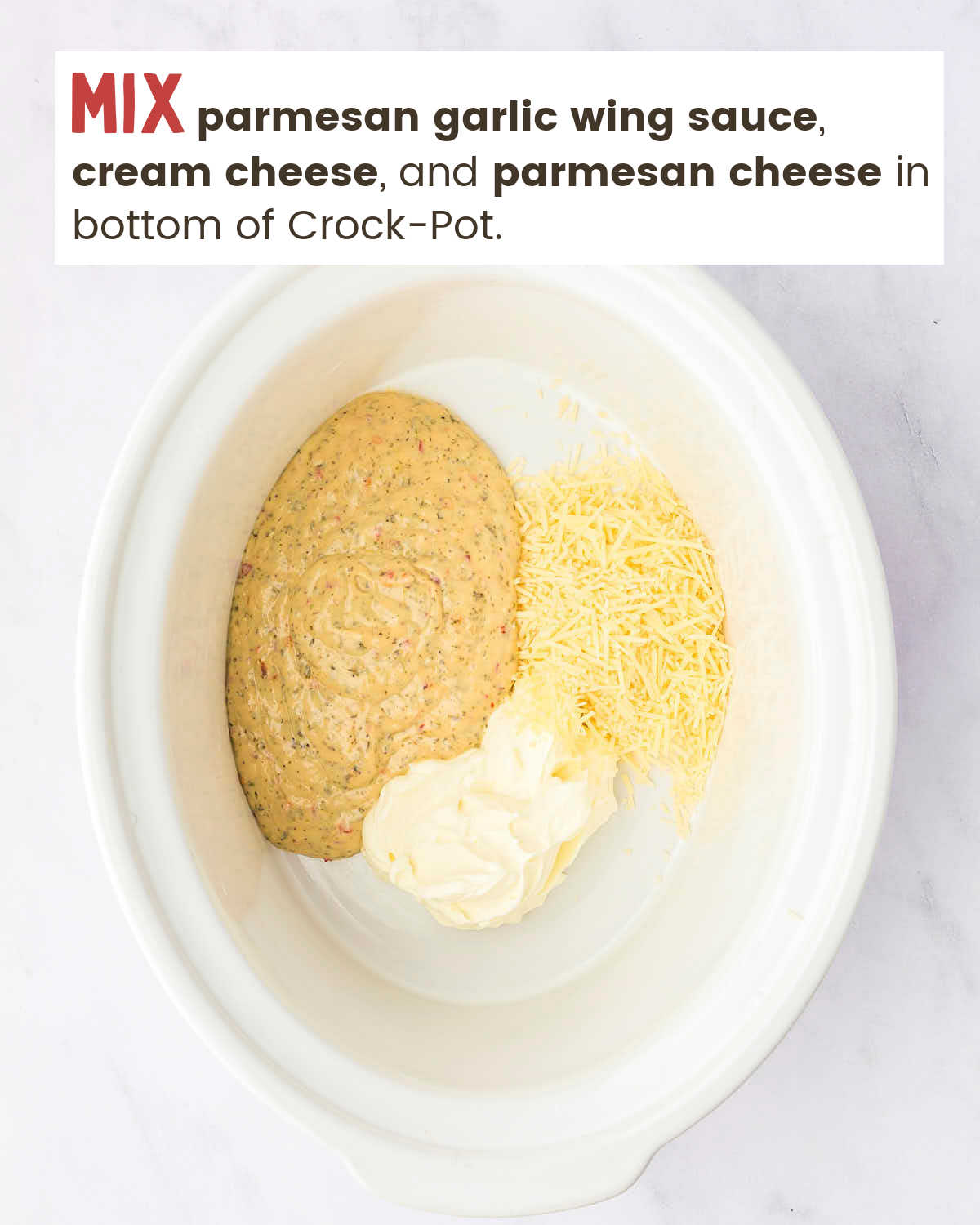 Wing sauce, parmesan cheese, and cream cheese in bottom of a Crock-Pot. 