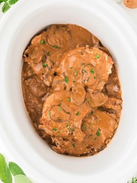 Topdown view of Pork Chops in a Crock Pot.