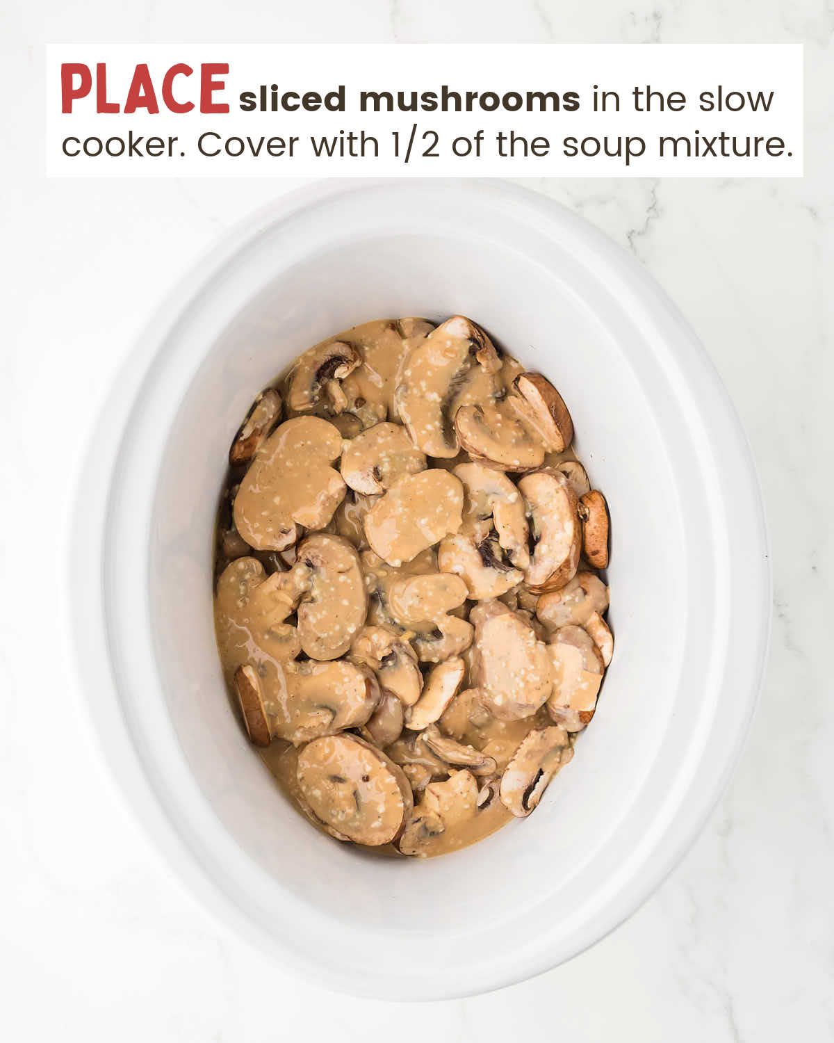 Sliced mushrooms in the bottom of a slow cooker covered with soup mixture.