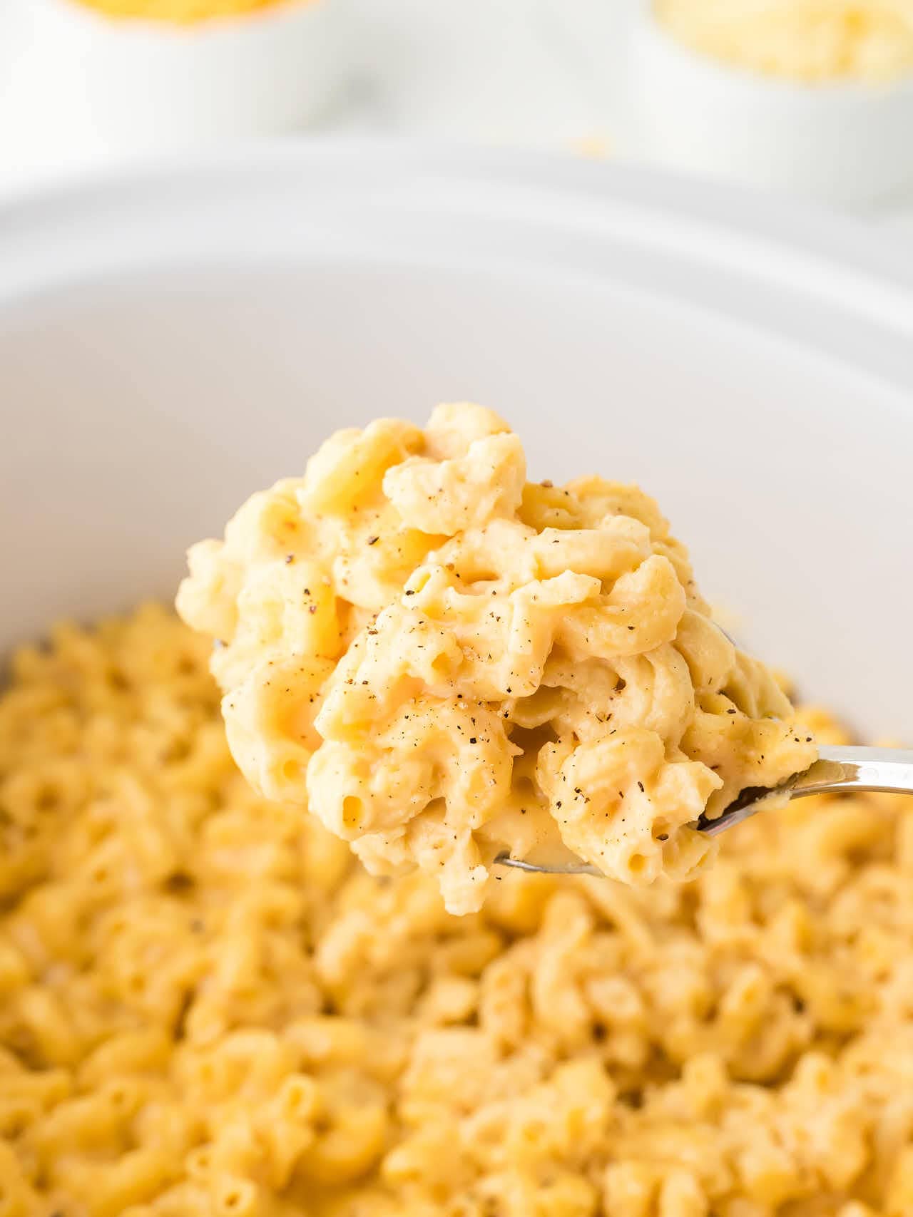 A serving spoon full of Crockpot Mac and Cheese.