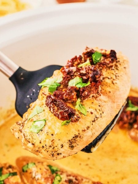 A spoonful of a slice of Crockpot Marry Me Chicken.