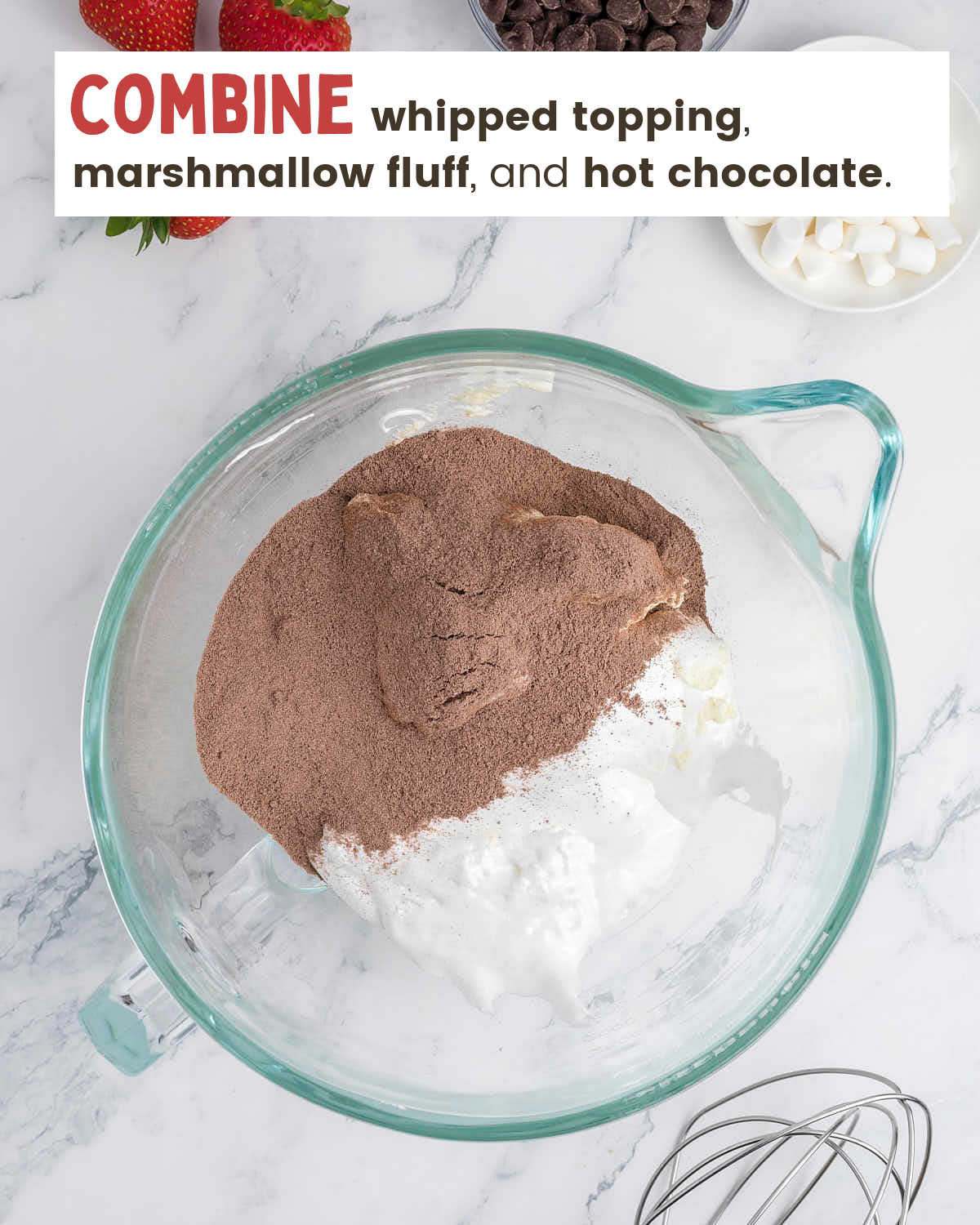Hot chocolate mix, marshmallow fluff, and whipped topping in a mixing bowl. 