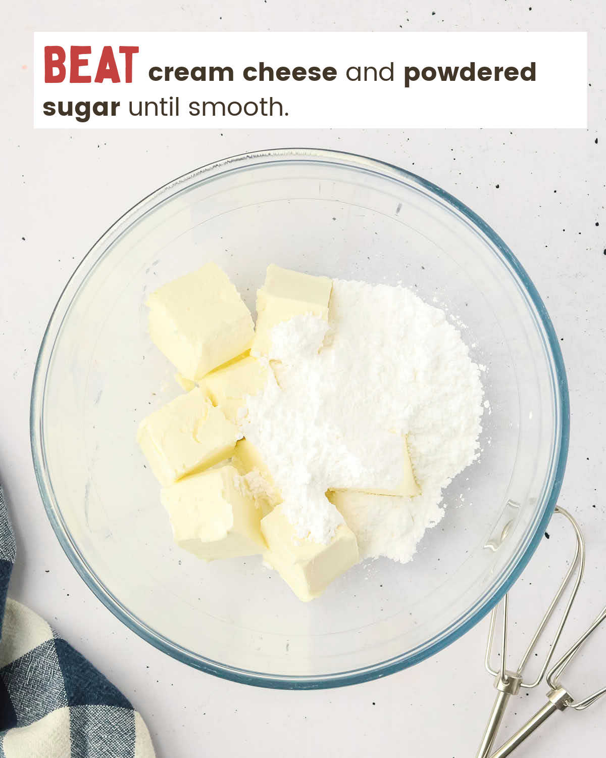 Cream cheese and powdered sugar in a mixing bowl.