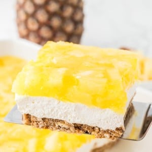 A slice of Pineapple Pretzel Salad on a spatula.