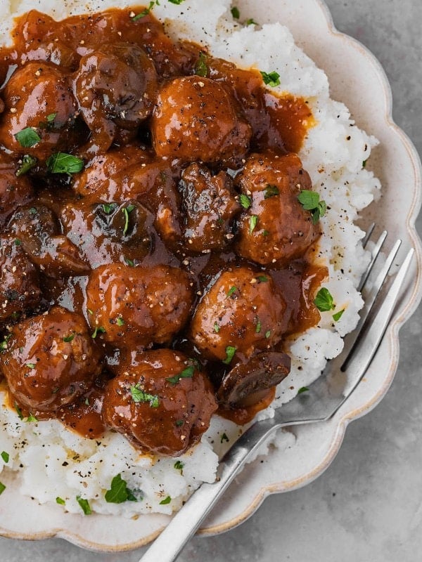 Closeup of Salisbury Steak Meatballs served over mashed potatoes.
