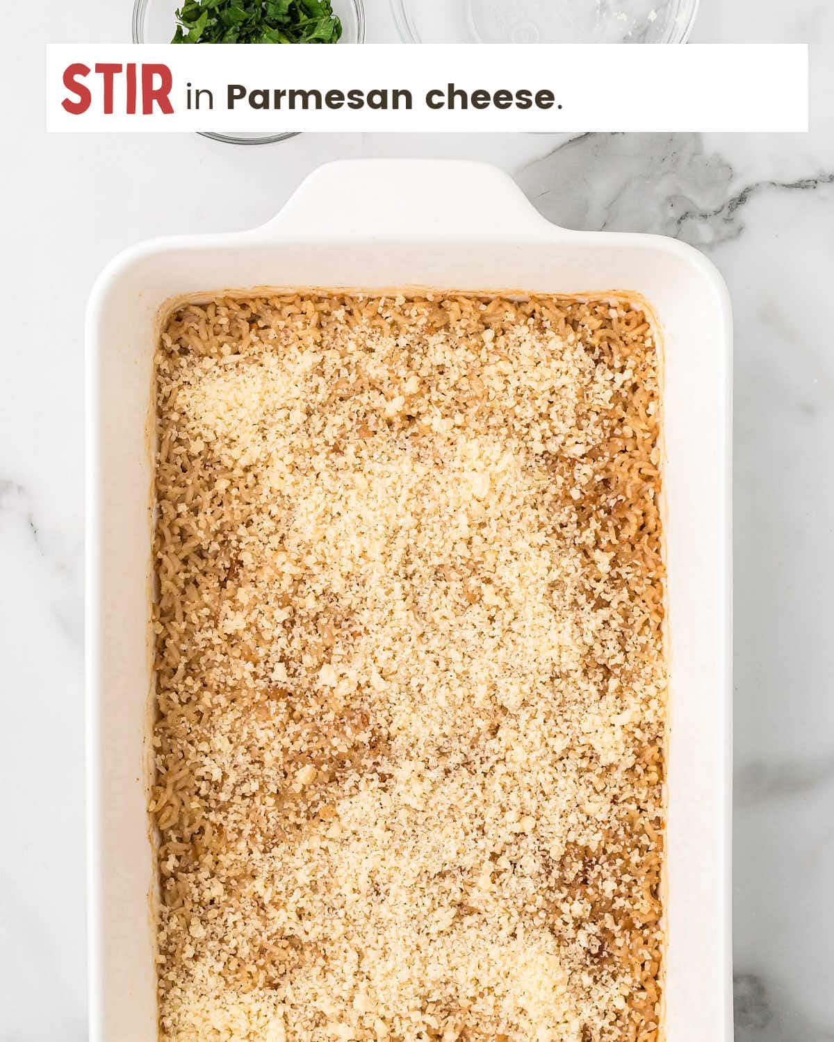Stich of butter rice with Parmesan cheese on top.