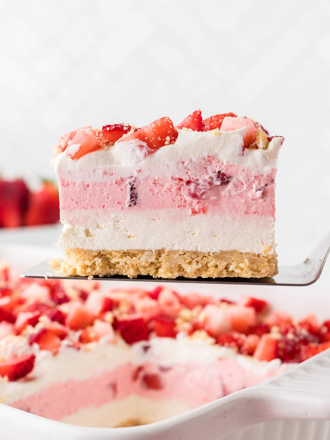 A slice of Strawberry Delight on a cake lifter.