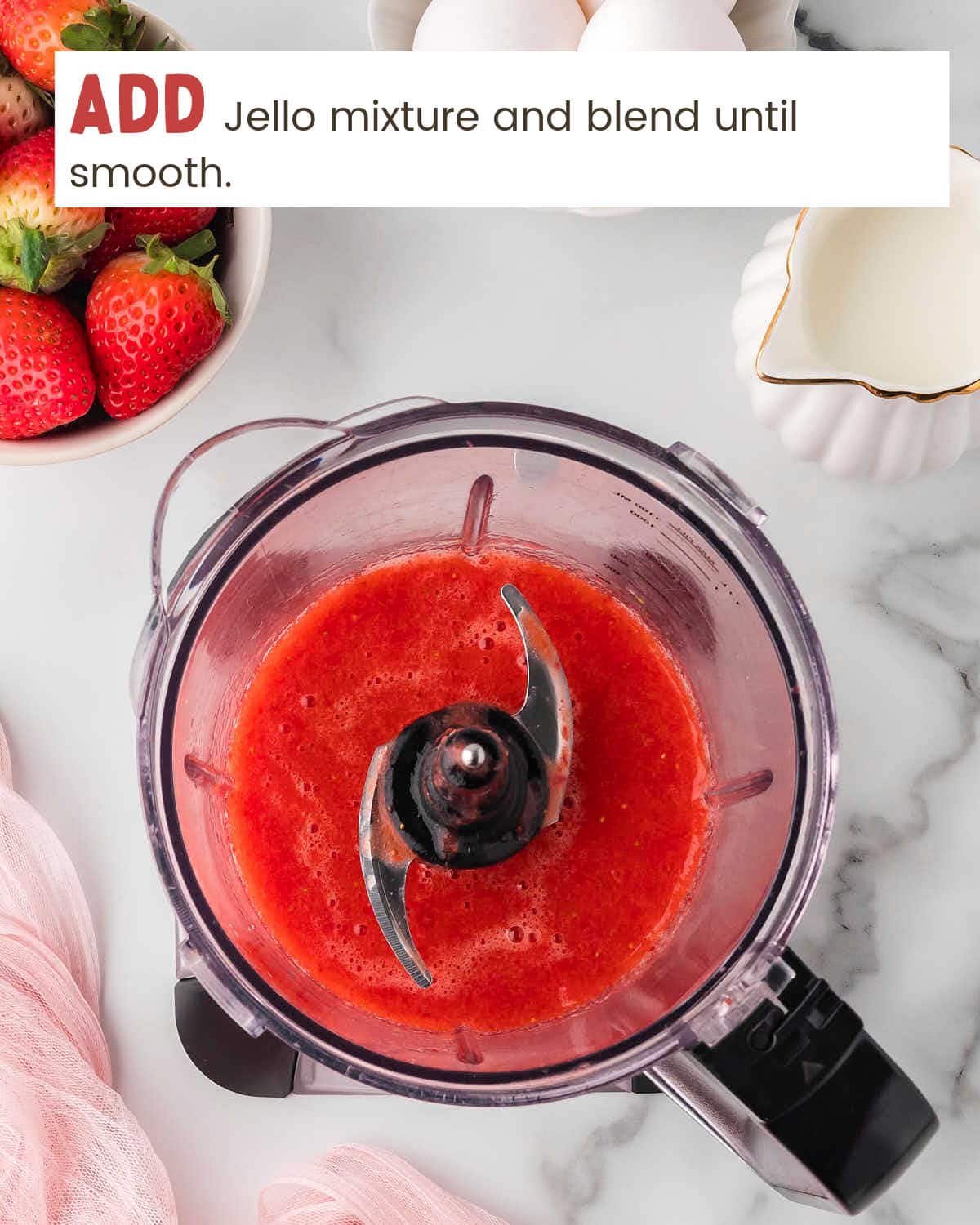 Top view of blended strawberries in a blender.