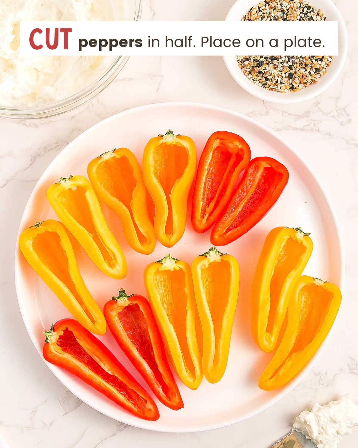 Mini peppers sliced in half on a plate. 