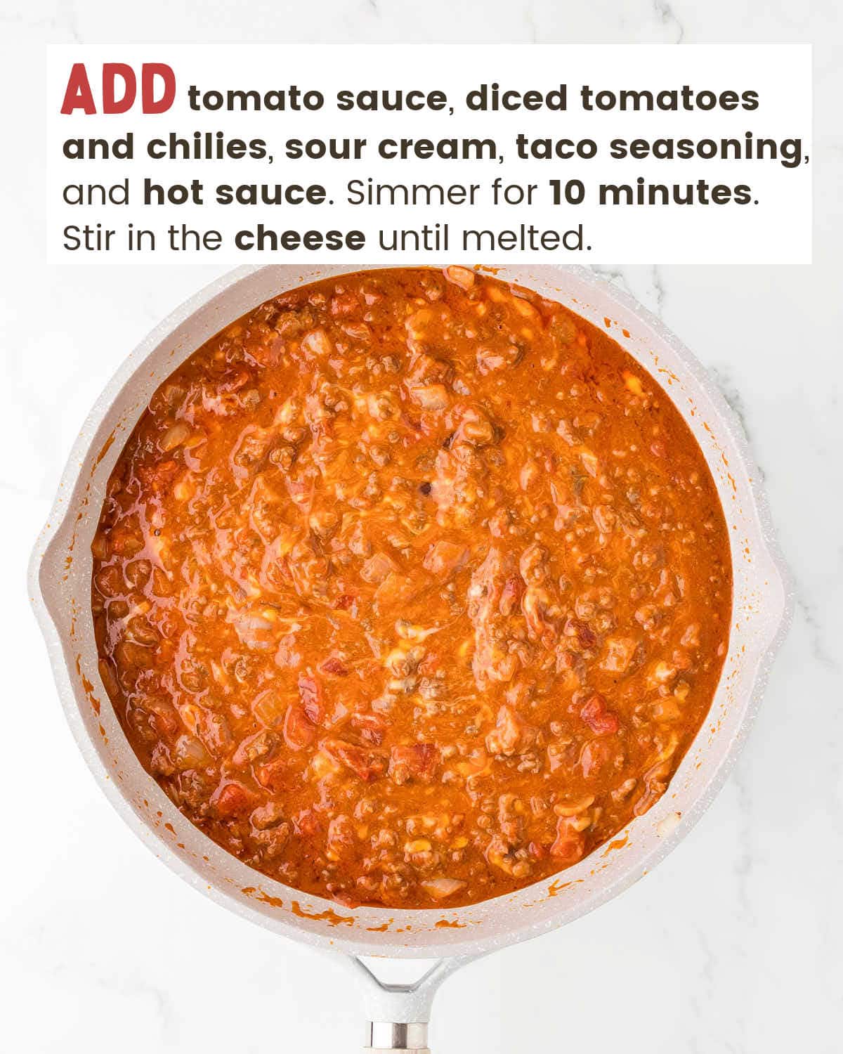Ground beef covered with homemade taco sauce in a skillet.